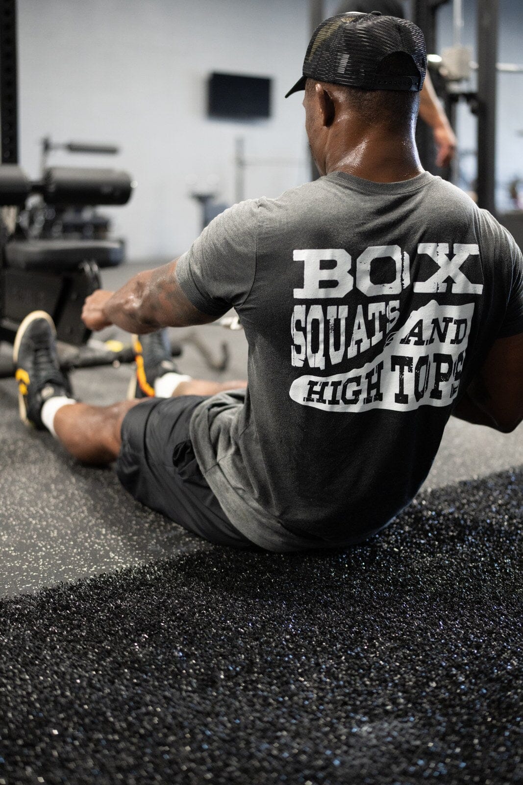 Lifter performing a seated one-arm cable row in a gym.