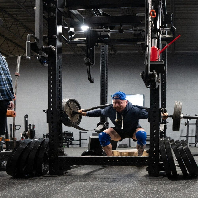 Athlete squatting with the Bow Bar to build control under load at Westside Barbell.