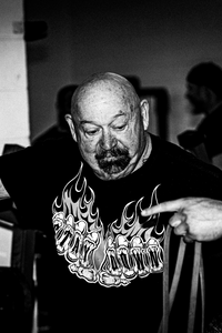 <h1 style="scroll-margin-top: 100px;" class="light-blue" id="louie-simmons">Louie Simmons</h1>
<h4>Founder of Westside Barbell</h4>
<p>Louie Simmons was a world-renowned Strength/Special Strengths coach and the founder of Westside Barbell. He was in the gym every day watching and analyzing all athletic training from all his powerlifters to track and field. Westside Barbell was a living laboratory for Louie where he conducted constant athletic experiments to push the boundaries of what is possible.  </p>
<p>Louie coached 24 athletes who deadlift over 800 pounds and three who deadlift over 900lbs, fifteen members who have a total lifting record over 2500 pounds and seven over 2600 pound total. Westside Barbell is the only gym in the world to have two over 2700 pound totals, plus five over 2800 pounds and one who has the biggest total of all time with 3005lbs.</p>
<p>Louie published over 300 training articles, authored eight books, and produced ten highly respected training videos. Louie Simmons also the invented the Reverse Hyper® machine, Inverse Curl machine, Hip/Quad machine, Static/Dynamic developer and the Virtual Force Swing.</p>
<p>He was a strength consultant for the Cleveland Browns, Green Bay Packers, Seattle Seahawks, and numerous college football teams. Louie worked closely with Kent Johnson, Johnny Parker, and Buddy Morris and a host of other professional and top-level strength coaches. Additionally, he trained 2 Olympic gold medal sprinters, Butch Reynolds and Moe Robinson, both 400-meter sprinters.</p>