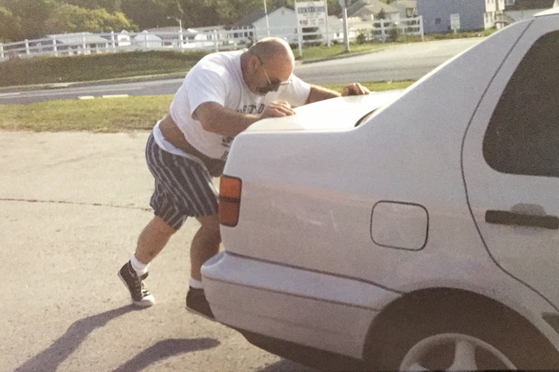 Pushing car in white Westside tee