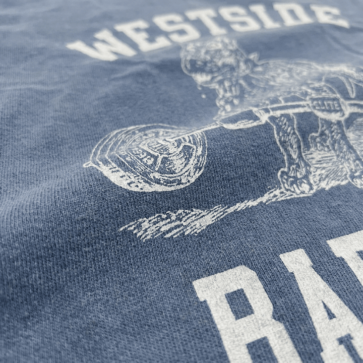 Macro close-up of garment-dyed cotton fabric texture on Westside Barbell washed denim t-shirt