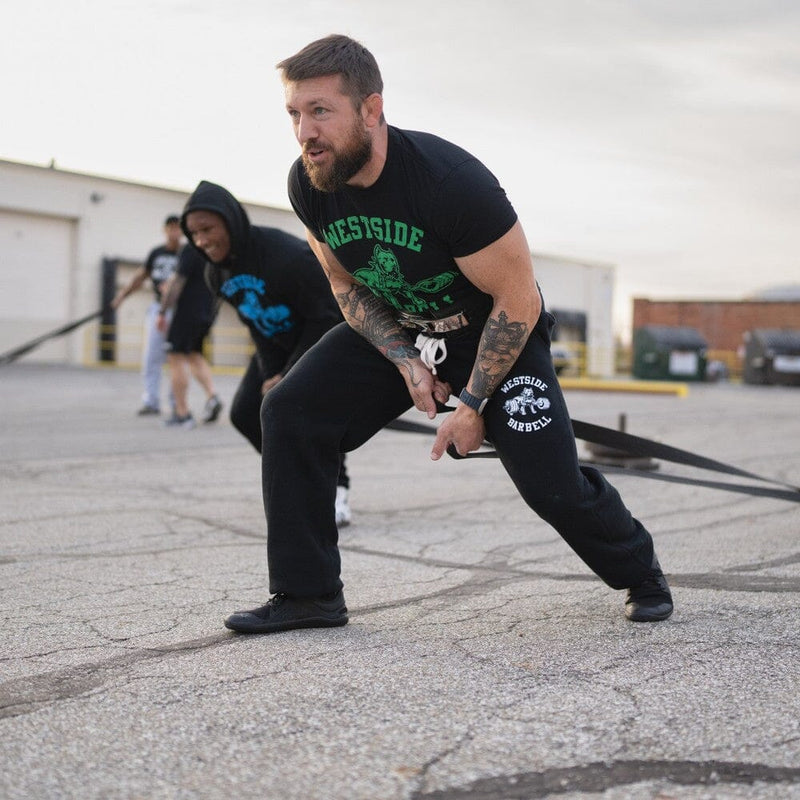 Athletes practicing sled duck walks as part of sled training at Westside Barbell.