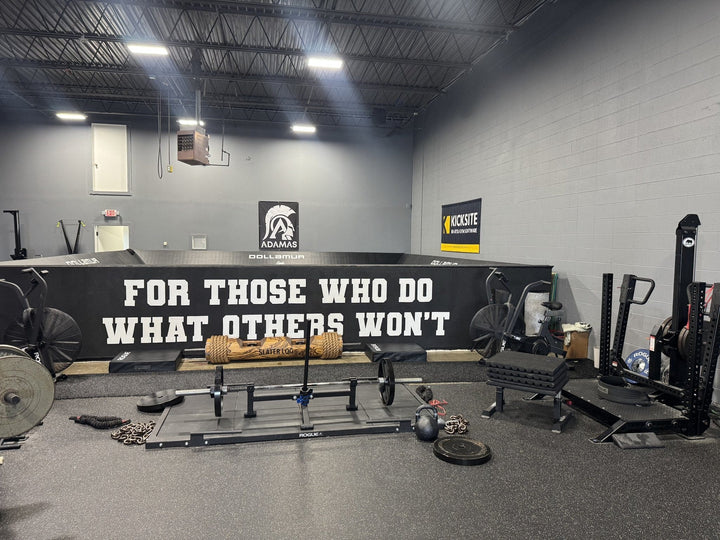 Westside Barbell Gym interior with weightlifting equipment and motivational banner.