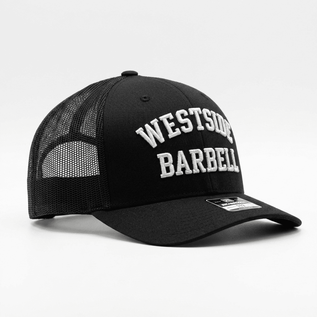 Three-quarter view of the Westside Barbell EST. 1972 black trucker snapback with embroidered front logo