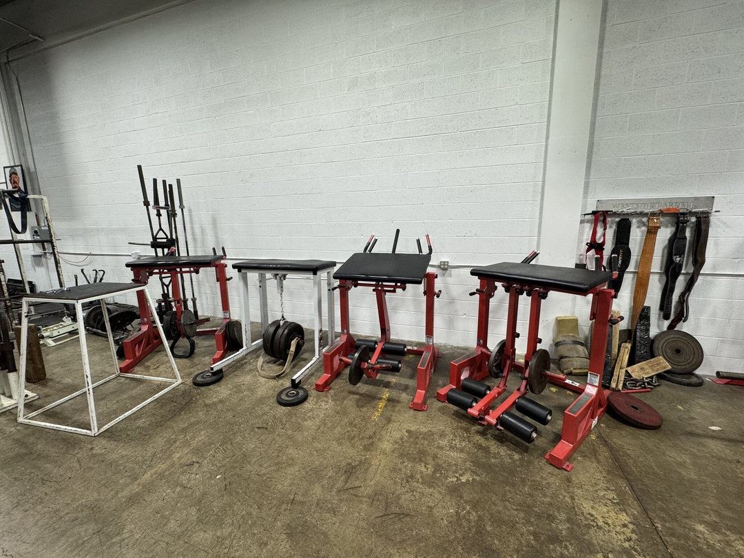 Westside Barbell  Set of weightlifting stands and equipment in a gym setting.